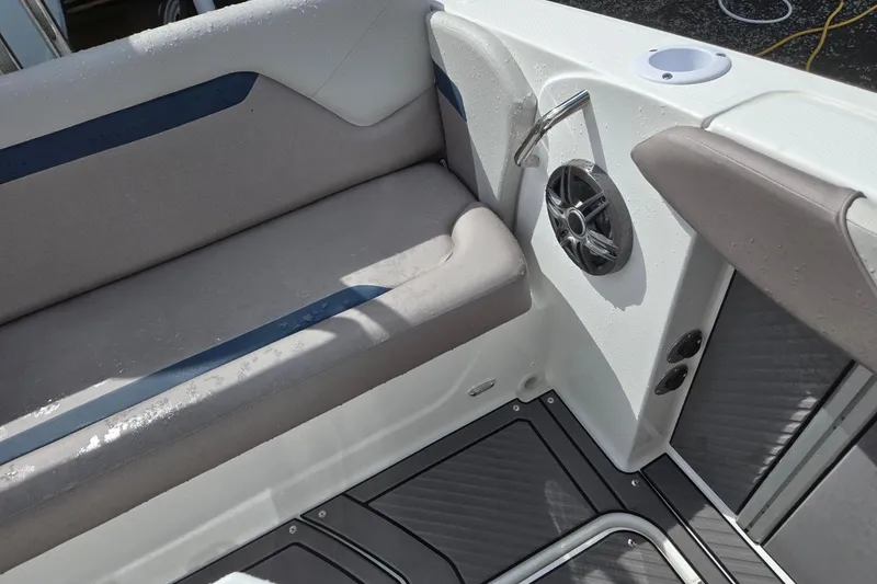 Slide: The Image of Interior of 2026 Hurricane Center Console 24 OB boat with cushioned seating and speaker. - 27