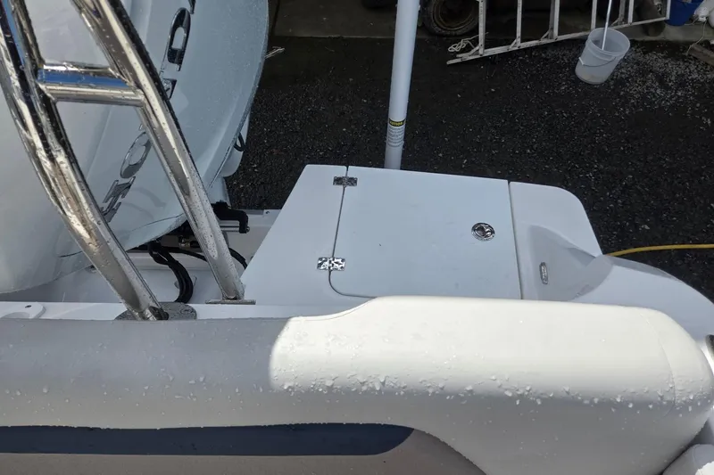 Slide: The Image of 2026 Hurricane Center Console 24 OB boat deck with chrome railing and storage compartment. - 33