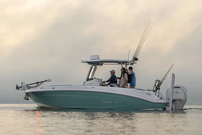 Slide: The Image of 2026 Hurricane Center Console 24 OB boat with powerful outboard motor, docked outdoors. - 6