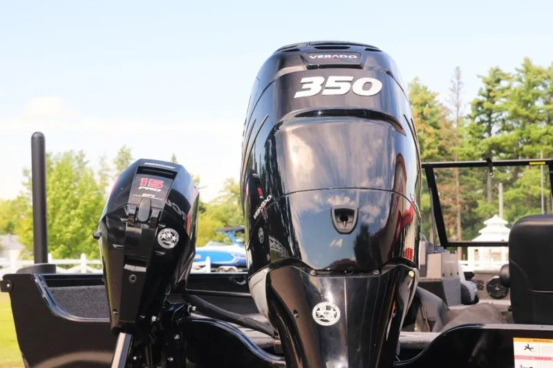 Slide: The Image of 2022 Crestliner 2100 Raptor with powerful Verado 350 and 15 HP engines, outdoors. - 12