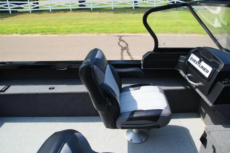 Slide: The Image of 2022 Crestliner 2100 Raptor boat interior with seating and dashboard view. - 8