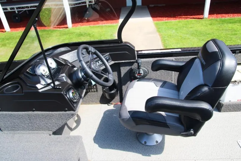 Slide: The Image of Interior of 2022 Crestliner 2100 Raptor boat showing steering wheel and captain's chair. - 9