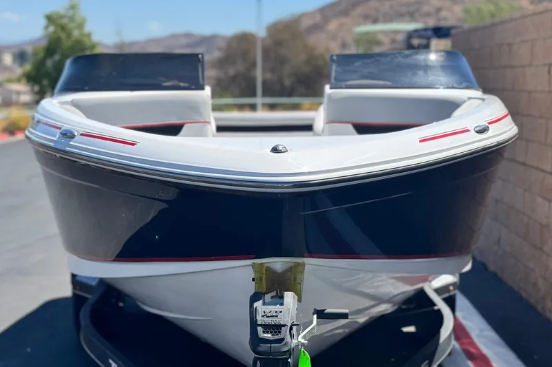 Slide: The Image of 2021 Tahoe T700 boat, front view, parked on a sunny day. - 2