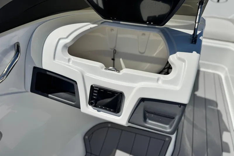 Slide: The Image of 2021 Tahoe T700 boat interior with open storage compartment and control panel. - 20