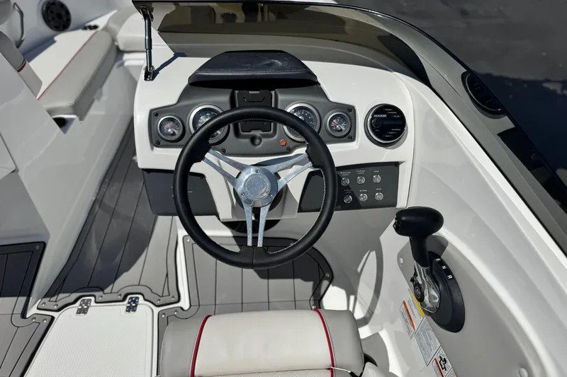 Slide: The Image of 2021 Tahoe T700 boat dashboard with steering wheel and control panel. - 23