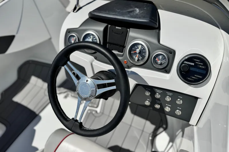 Slide: The Image of Steering wheel and dashboard of 2021 Tahoe T700 boat with gauges and controls. - 24