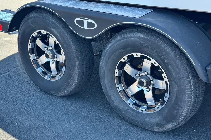 Slide: The Image of Dual wheels of a 2021 Tahoe T700 trailer with chrome rims. - 25