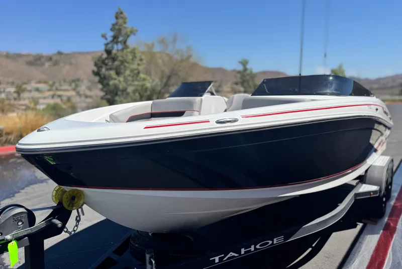 Slide: The Image of 2021 Tahoe T700 boat on trailer, sleek design, outdoors. - 3