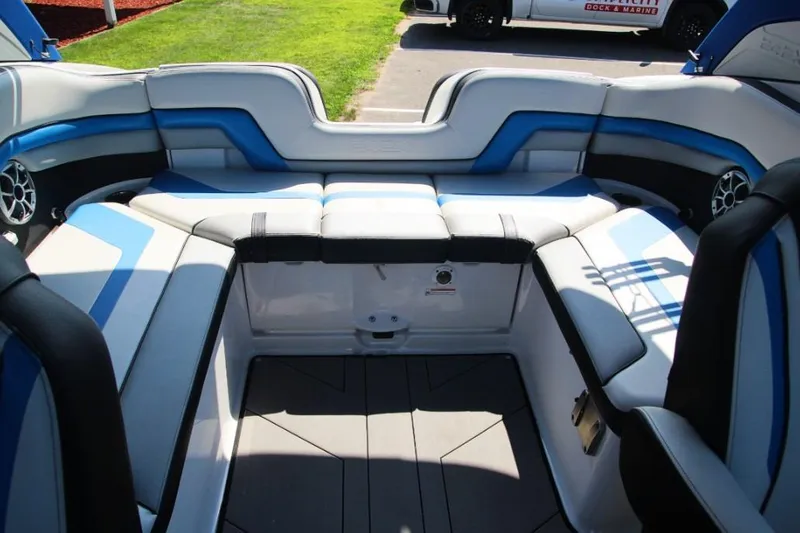 Slide: The Image of 2019 Yamaha Boats 242X interior with blue and white seating, showcasing spacious design. - 14