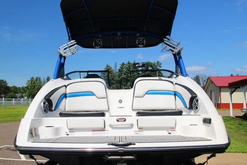 Slide: The Image of 2019 Yamaha Boats 242X, rear view, showcasing sleek design and spacious seating. - 4