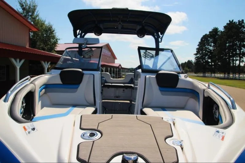 Slide: The Image of 2019 Yamaha Boats 242X interior with seating and open deck, under sunny skies. - 6