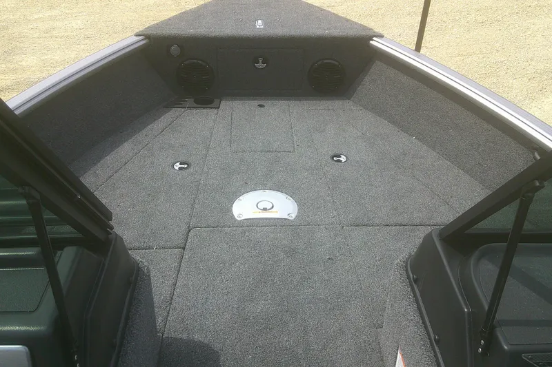 Slide: The Image of 2026 Lund 1875 Impact XS Sport boat interior with carpeted deck and storage compartments. - 6
