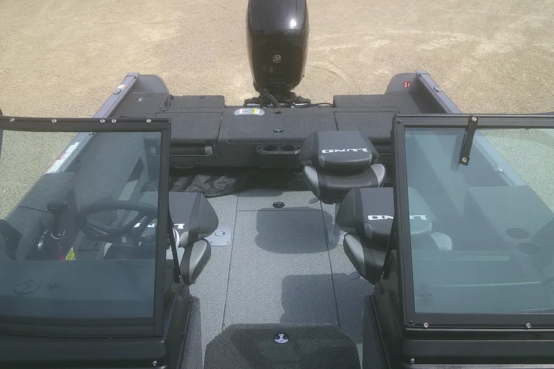 Slide: The Image of 2026 Lund 1875 Impact XS Sport boat interior with seating and steering wheel. - 9