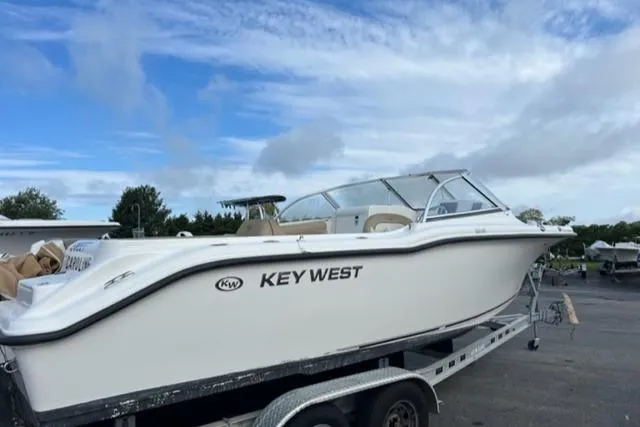 Slide: The Image of 2019 Key West 239 DFS boat on trailer under blue sky. - 0