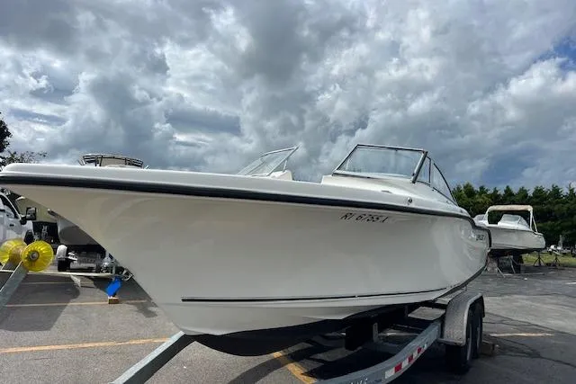 Slide: The Image of 2019 Key West 239 DFS boat on trailer under cloudy sky. - 5