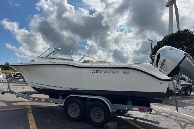 Slide: The Image of 2019 Key West 239 DFS boat on trailer under cloudy sky. - 6