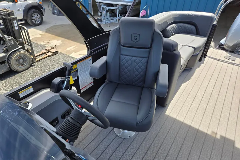 Slide: The Image of 2026 Godfrey SWEETWATER 2286 SB boat interior with luxurious seating and steering console. - 19