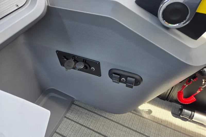 Slide: The Image of Control panel of 2026 Godfrey SWEETWATER 2286 SB boat with switches and red safety cord. - 24