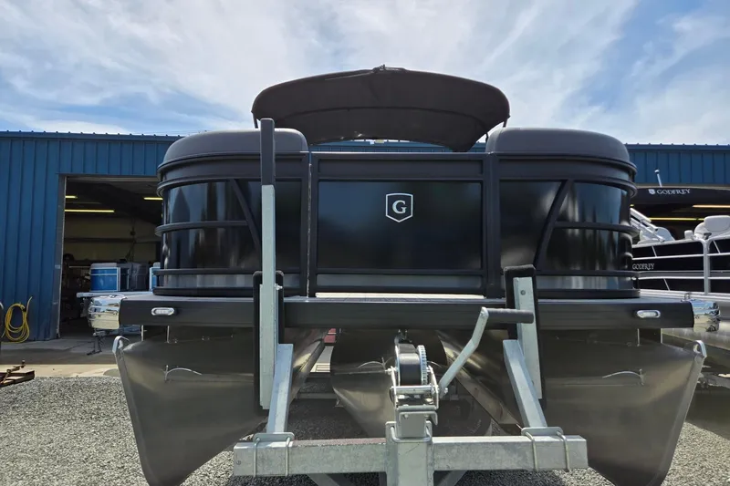 Slide: The Image of 2026 Godfrey SWEETWATER 2286 SB pontoon boat on trailer, blue building background. - 3