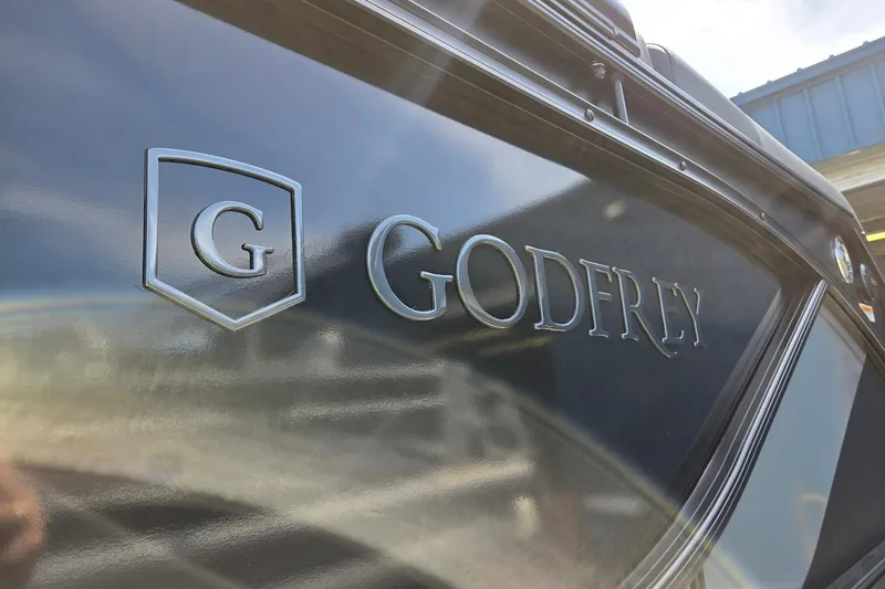 Slide: The Image of Close-up of 2026 Godfrey SWEETWATER 2286 SB boat logo on sleek black surface. - 42