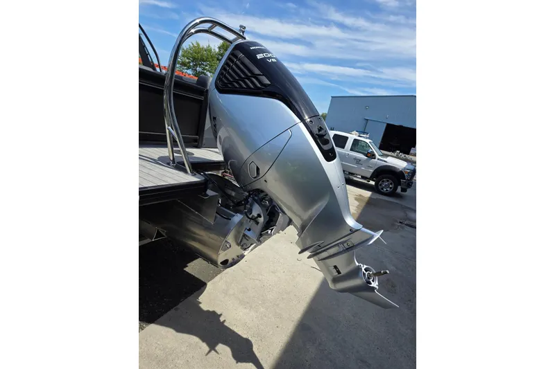 Slide: The Image of 2026 Godfrey SWEETWATER 2286 SB boat with powerful outboard motor in a sunny outdoor setting. - 45