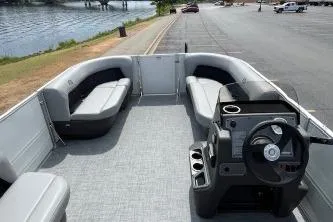 Slide: The Image of 2026 Sun Tracker Bass Buggy 16 DLX pontoon boat with spacious seating and modern console. - 5