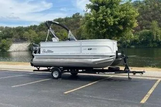 Slide: The Image of 2026 Sun Tracker Bass Buggy 16 DLX pontoon boat on trailer in parking lot. - 7
