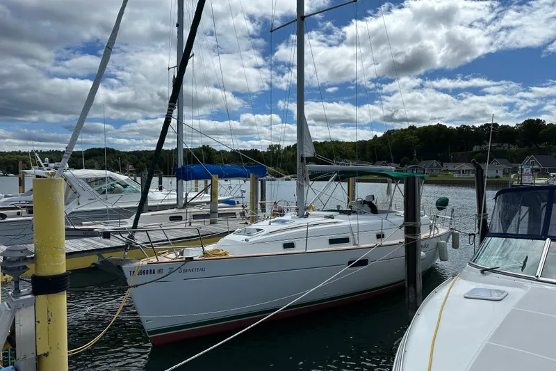 The Image of Beneteau Oceanis 36 CC sailboat docked at marina, 2000 model, under a partly cloudy sky. - 0