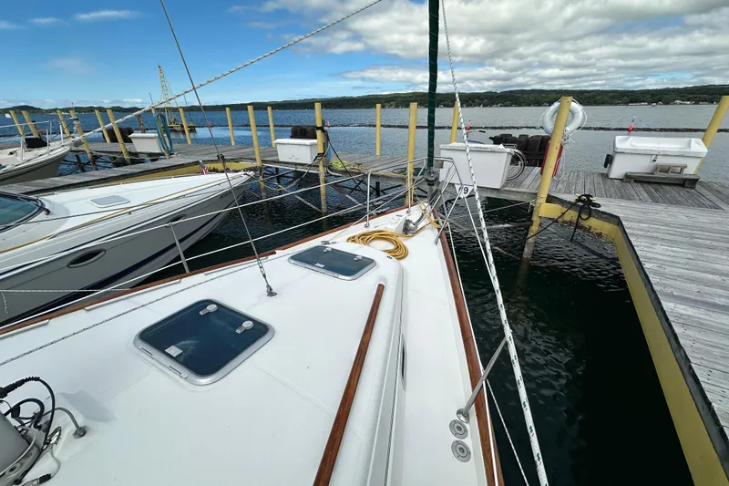 Slide: The Image of Beneteau Oceanis 36 CC sailboat docked at marina, 2000 model, calm waters, clear sky. - 13