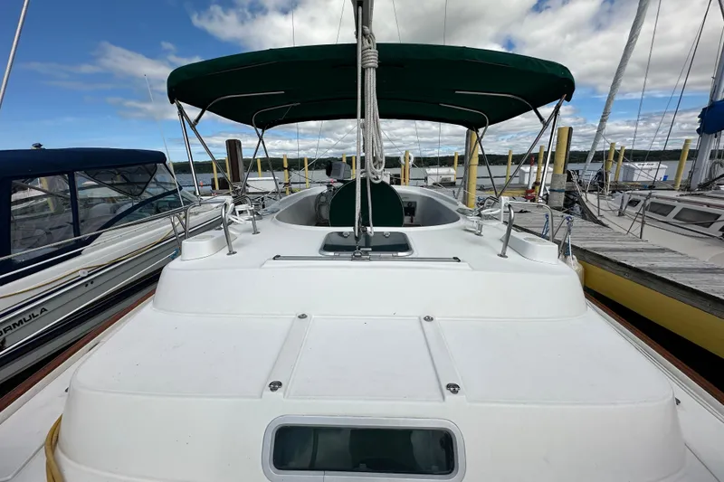 Slide: The Image of Beneteau Oceanis 36 CC sailboat, 2000 model, docked at marina under blue sky. - 14