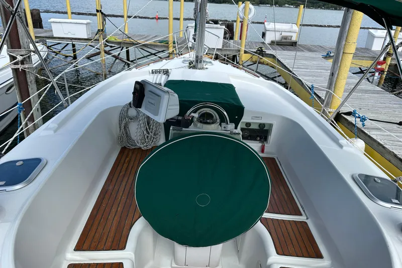 Slide: The Image of Cockpit of 2000 Beneteau Oceanis 36 CC sailboat with green covers and wooden flooring. - 22