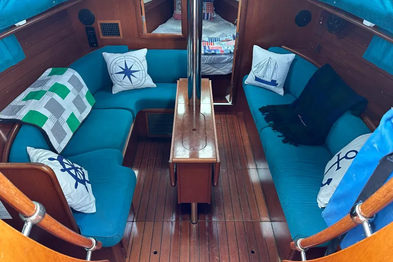 Slide: The Image of Interior of 2000 Beneteau Oceanis 36 CC sailboat with blue seating and nautical decor. - 27