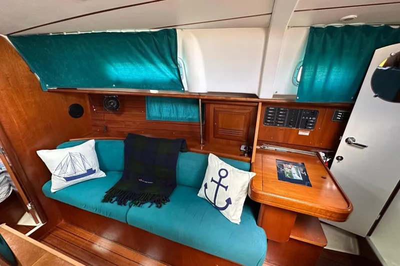 Slide: The Image of Cozy interior of 2000 Beneteau Oceanis 36 CC sailboat with teal accents and nautical decor. - 31