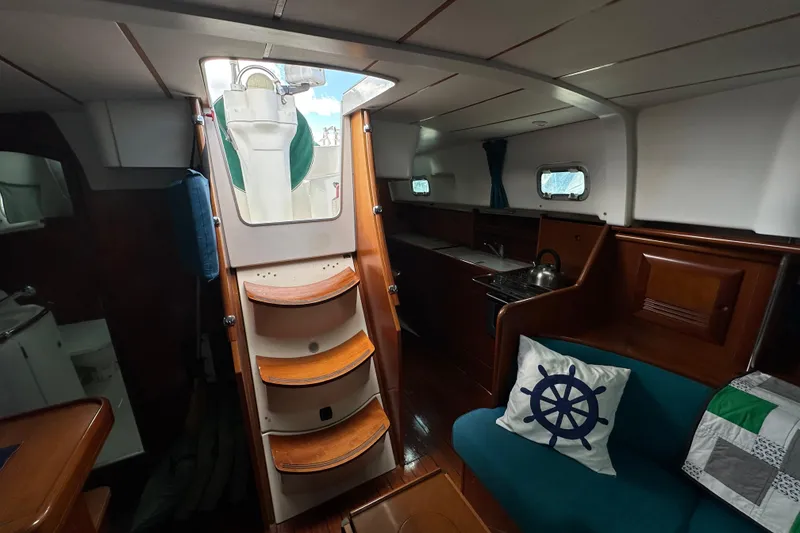 Slide: The Image of Interior of 2000 Beneteau Oceanis 36 CC sailboat with cozy seating and compact kitchen. - 33