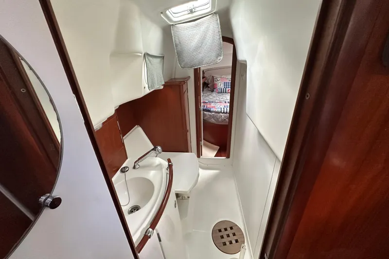 Slide: The Image of Interior of 2000 Beneteau Oceanis 36 CC yacht, featuring compact bathroom and cozy cabin. - 34