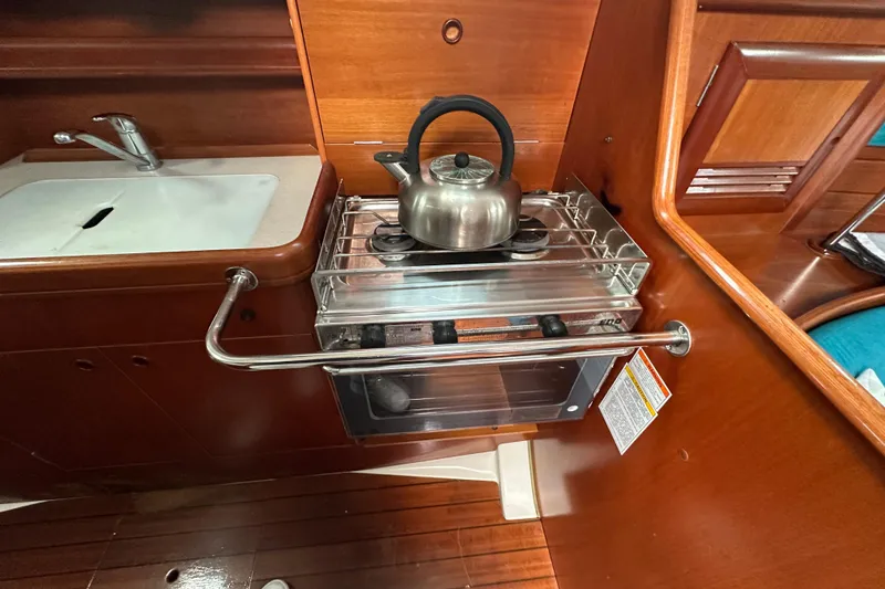 Slide: The Image of Galley of 2000 Beneteau Oceanis 36 CC with stove, kettle, and sink. - 41