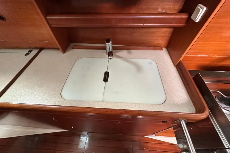 Slide: The Image of Beneteau Oceanis 36 CC 2000 yacht kitchen sink with wooden cabinetry. - 42