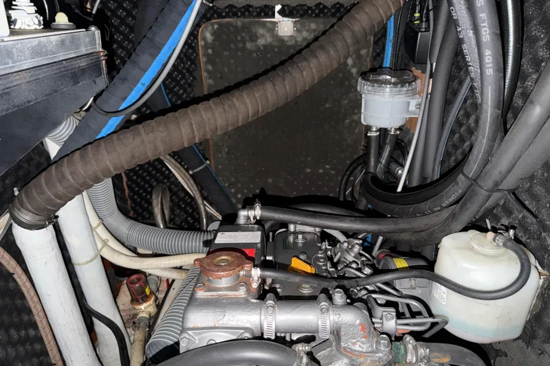 Slide: The Image of Engine compartment of a 2000 Beneteau Oceanis 36 CC sailboat, showing hoses and components. - 47