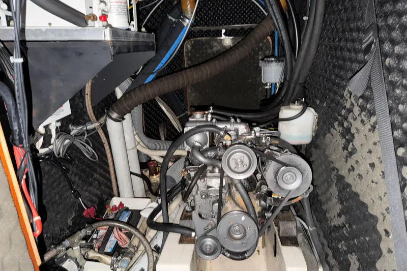 Slide: The Image of Engine compartment of a 2000 Beneteau Oceanis 36 CC sailboat, showcasing mechanical components. - 48