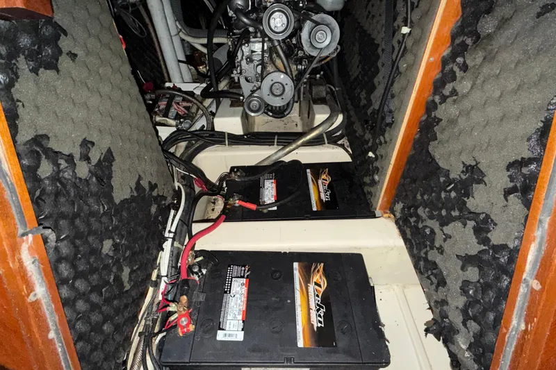 Slide: The Image of Engine compartment of 2000 Beneteau Oceanis 36 CC with batteries and insulation. - 49