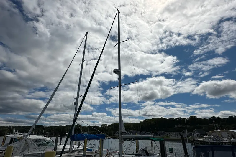 Slide: The Image of Sailboat Beneteau Oceanis 36 CC, 2000 model, docked under a partly cloudy sky. - 7