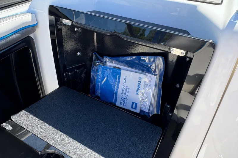 Slide: The Image of 2020 Yamaha AR240 boat storage compartment with manual inside. - 22