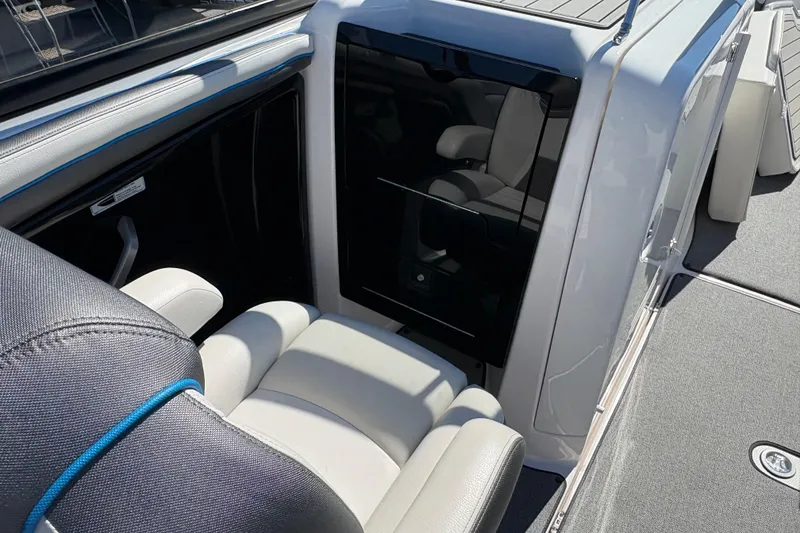 Slide: The Image of 2020 Yamaha Boats AR240 interior seating and storage area, featuring sleek design and comfortable upholstery. - 23
