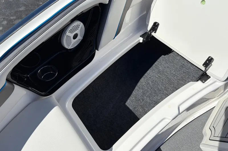 Slide: The Image of 2020 Yamaha AR240 boat storage compartment with speaker and cup holders. - 25