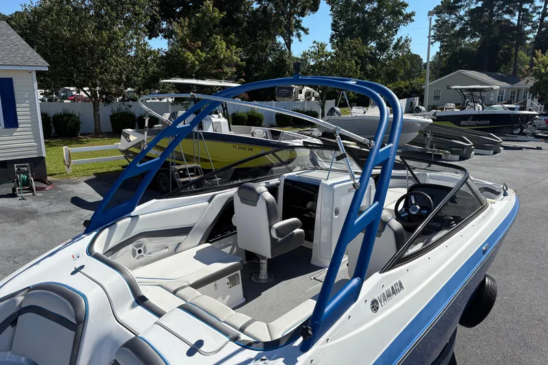Slide: The Image of 2020 Yamaha Boats AR240 with blue accents, parked outdoors on a sunny day. - 6