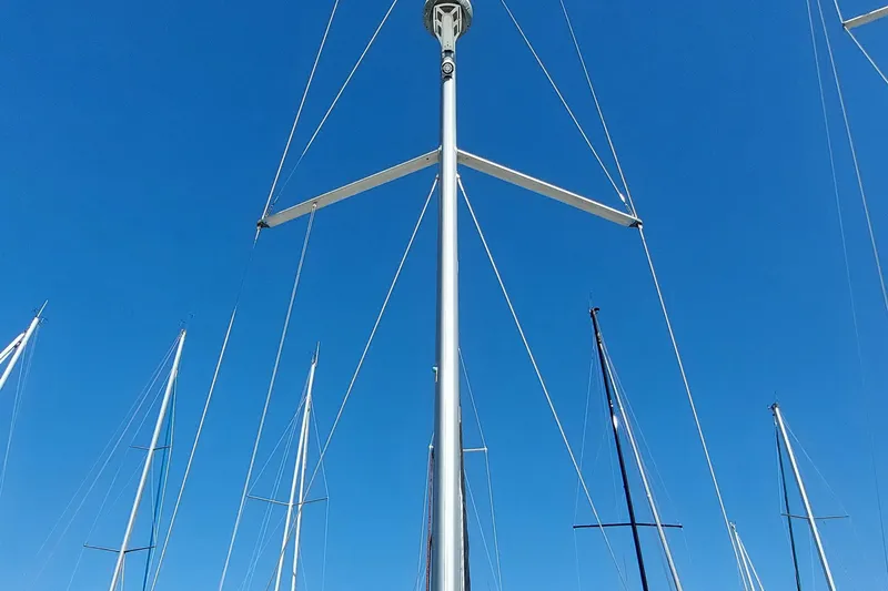 Slide: The Image of Masts of Beneteau Oceanis 45 sailboats against a clear blue sky. - 14