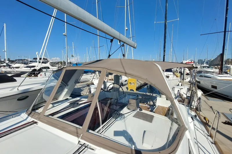 Slide: The Image of 2015 Beneteau Oceanis 45 sailboat docked at marina under clear blue sky. - 17