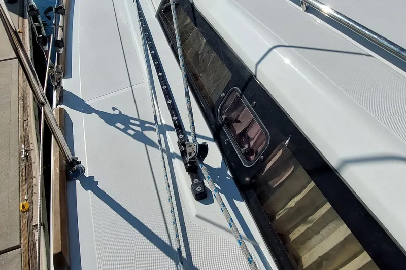 Slide: The Image of Deck view of a 2015 Beneteau Oceanis 45 sailboat, showcasing rigging and window details. - 19