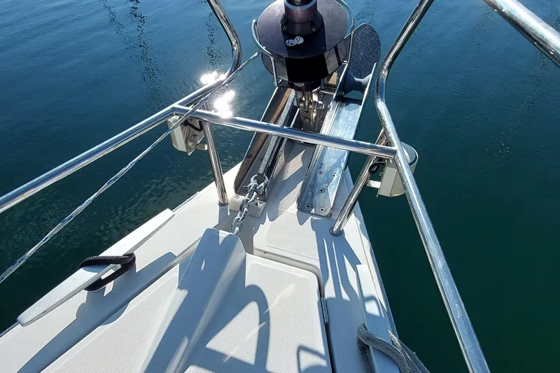 Slide: The Image of Bow of 2015 Beneteau Oceanis 45 sailboat with anchor and railing over calm water. - 21