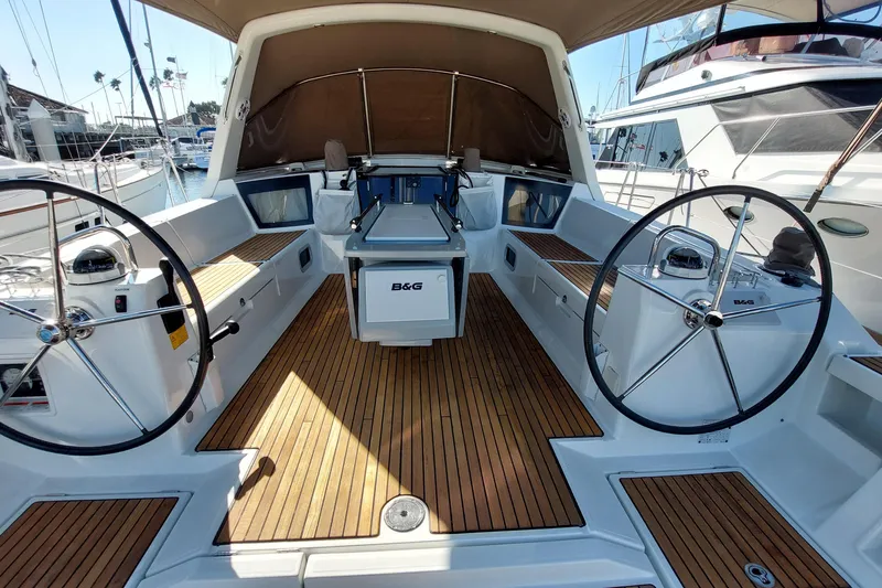 Slide: The Image of 2015 Beneteau Oceanis 45 yacht cockpit with dual steering wheels and teak flooring. - 26